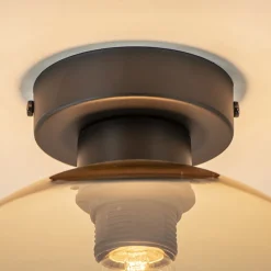 Mat zwarte plafondlamp met amber glazen bol